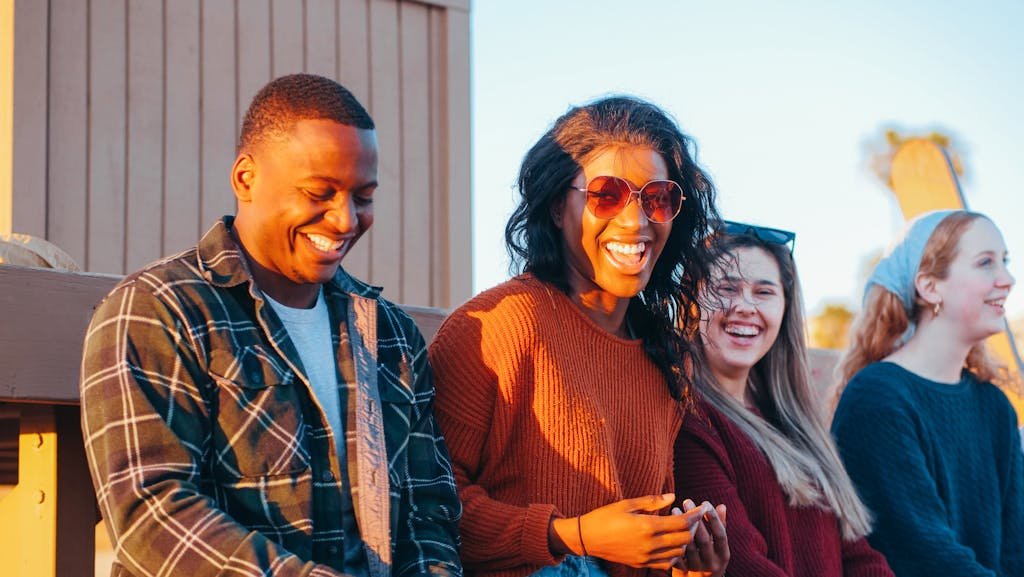 Group of Friends Sitting Near Lifeguard Post